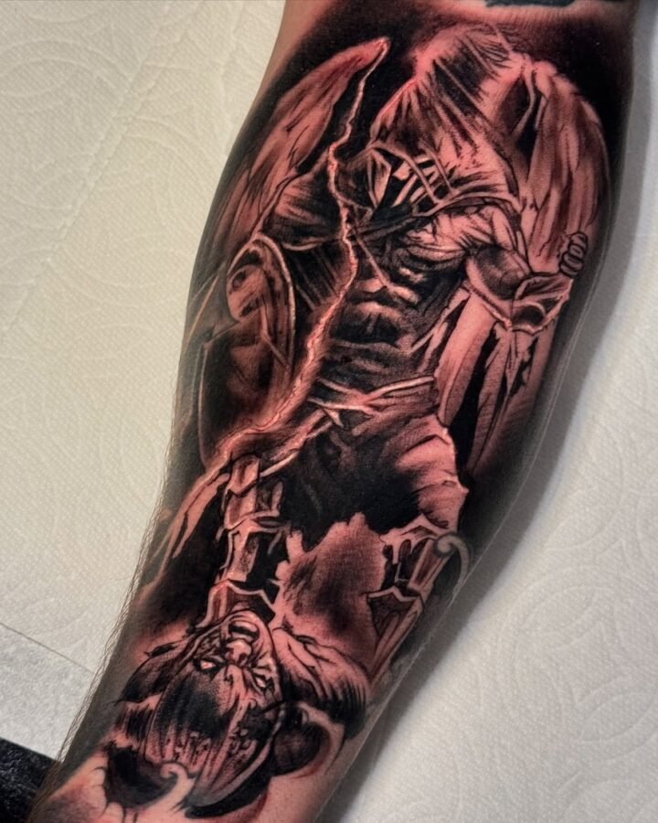 Black and grey reaper and skeleton sleeve tattoo on the forearm